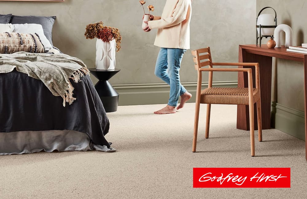 Soft beige carpet flooring in a modern bedroom with stylish decor and wooden furniture.