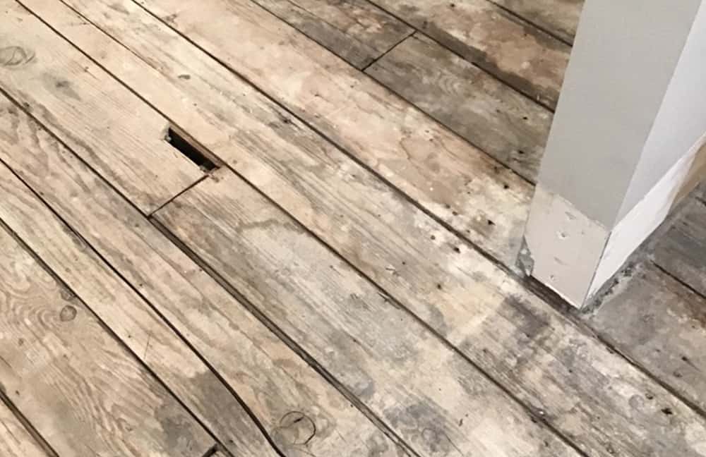 Weathered wooden flooring with natural rustic appeal, suitable for flooring restoration projects.