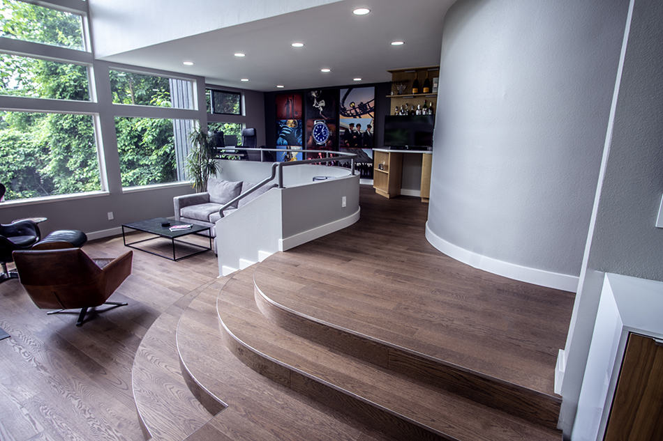 Smooth hardwood flooring in a modern living room with large windows and contemporary decor.