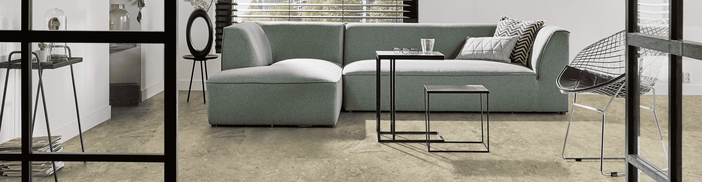 MarmoleumFlooring Modern living room with concrete flooring and stylish furniture in Dallas Watson Flooring showroom.