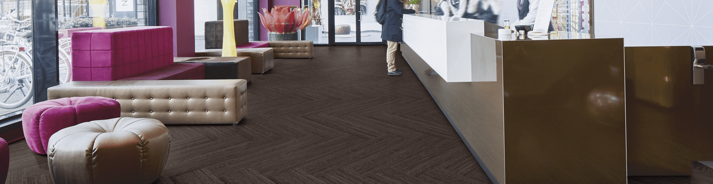 commericial Luxurious dark hardwood flooring in modern hotel lobby with stylish seating areas and large windows.